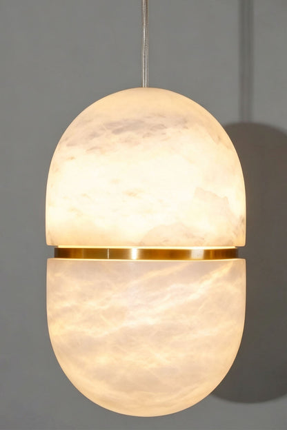 Isaline Banded Capsule Alabaster Pendant Light featuring a sleek design with a gold band accent.