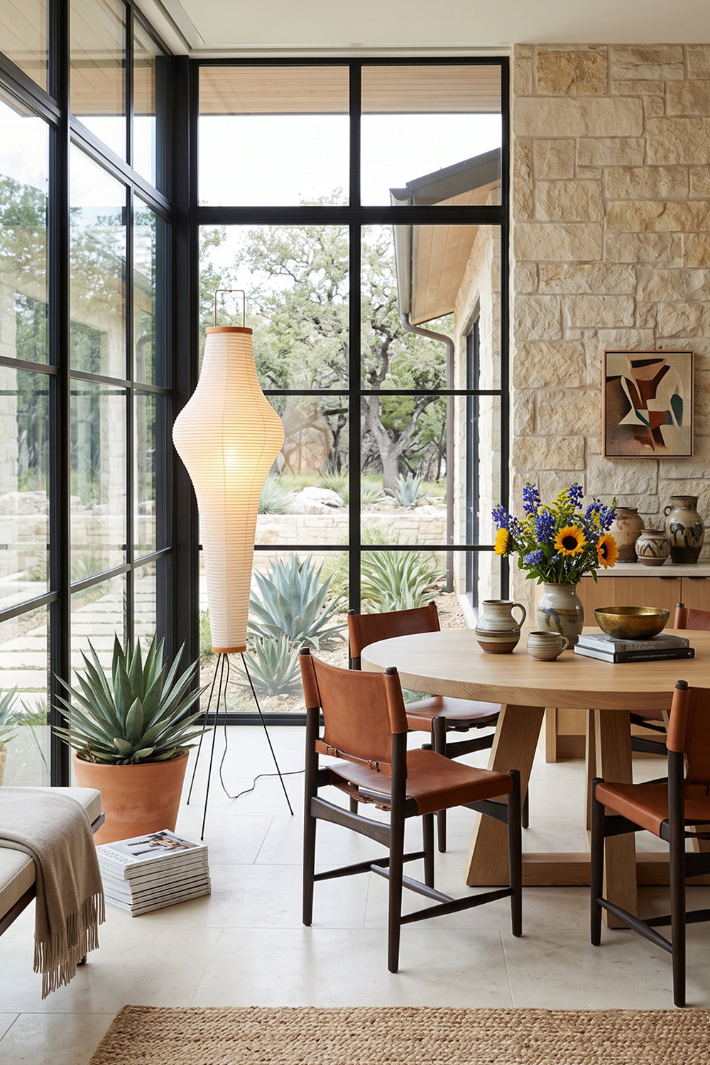 Isolde Ribbed Paper Column Floor Lamp in stylish dining area with natural light and plants.