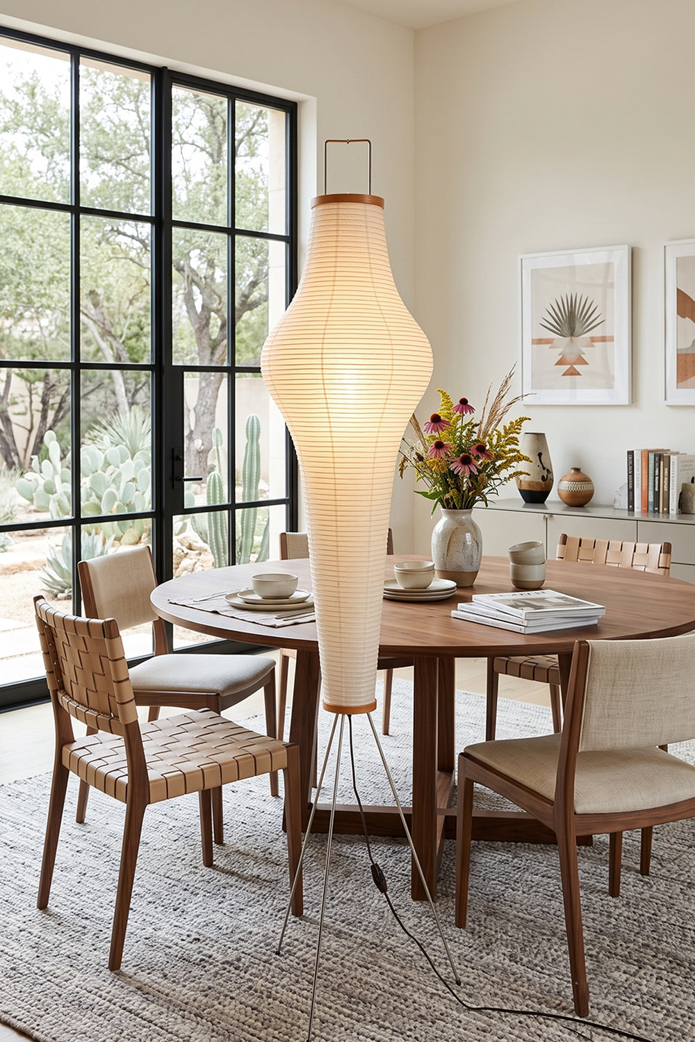 Isolde Ribbed Paper Column Floor Lamp illuminating a modern dining space with wooden furniture.