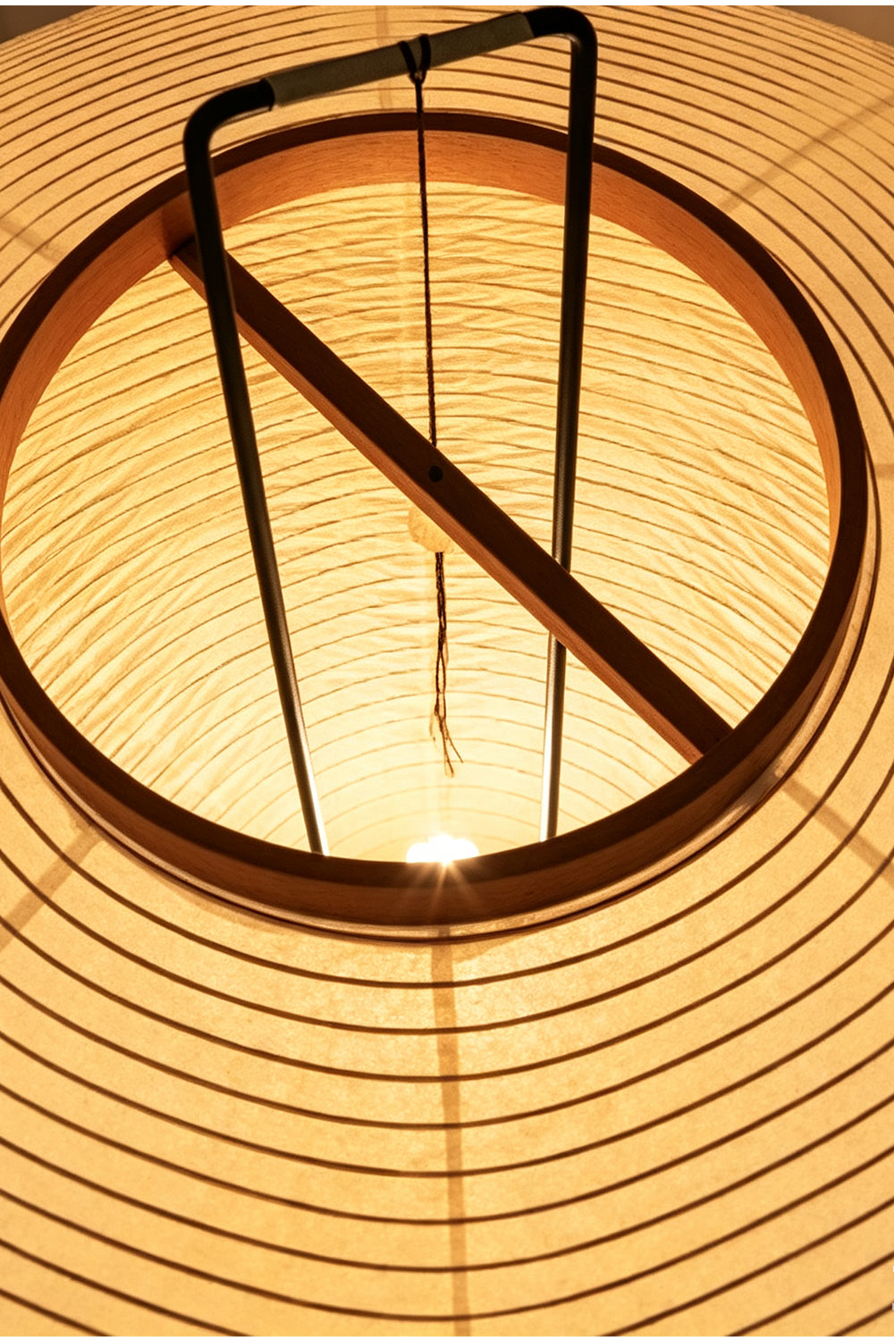 Isolde Ribbed Paper Column Floor Lamp showing the interior lamp structure and warm, diffused light.