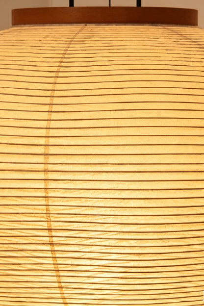 Isolde Ribbed Paper Column Floor Lamp close-up showing the ribbed paper shade casting a warm, diffuse glow.
