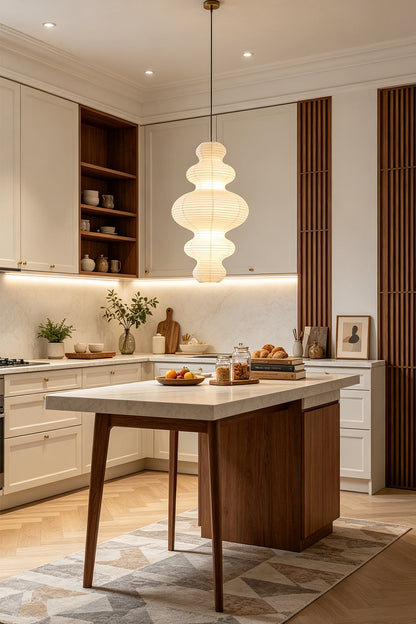 Isolde Stacked Paper Pendant Lamp | Textured Ribbed Paper | Suspended over a contemporary kitchen island with wooden bar stools and white cabinets | vexa lamps