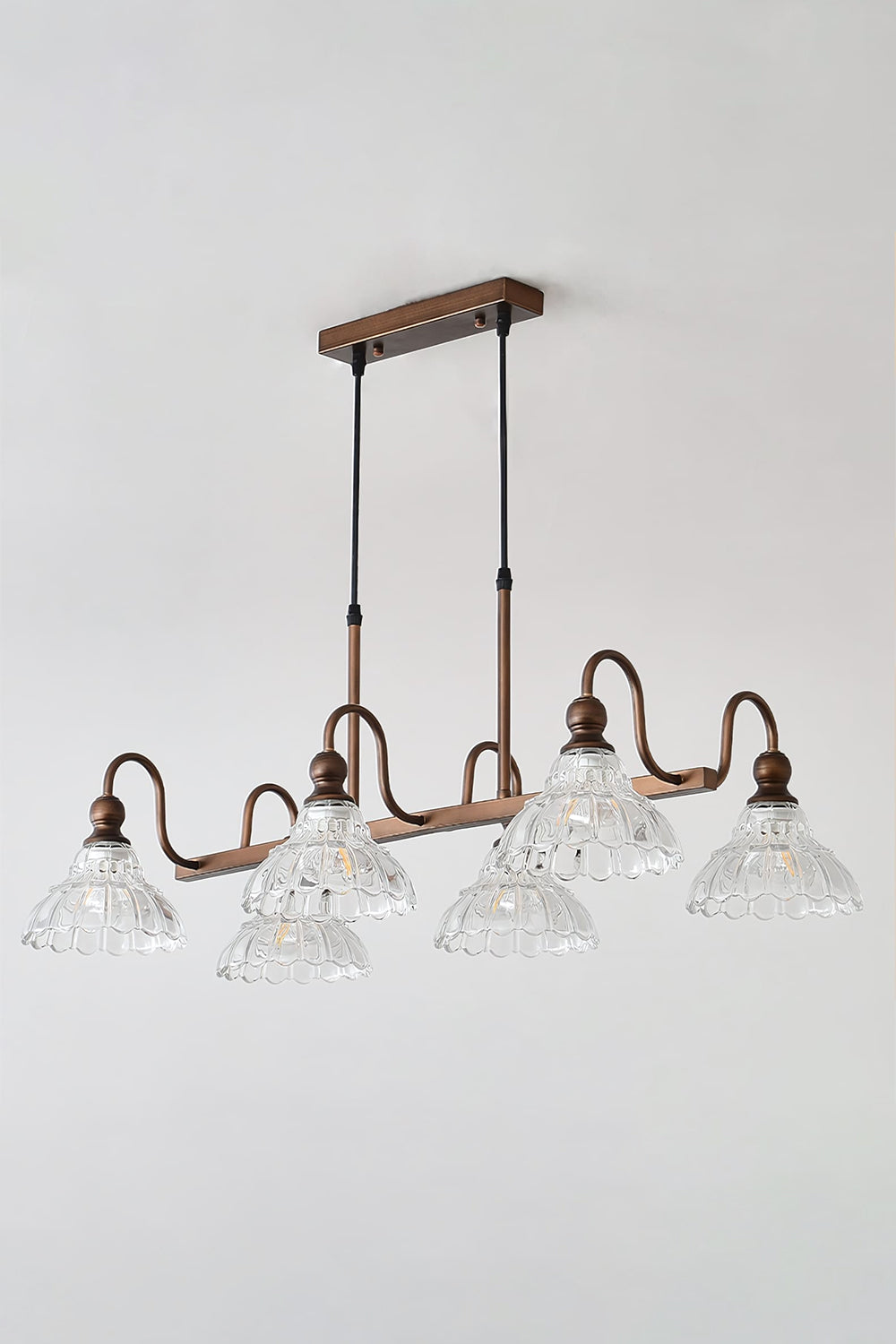 Isolde Vintage Glass Long Chandelier | Studio Lit View | Fully illuminated multi-light vintage linear pendant lamp casting a bright ambient glow against a clean white backdrop | vexa lamps