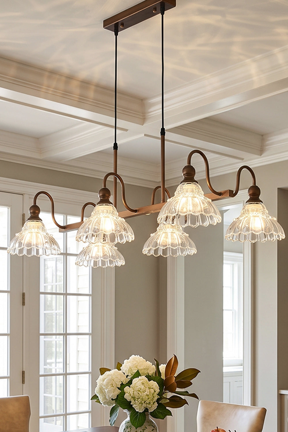 Isolde Vintage Glass Long Chandelier | Ambient Room Light | Staged ceiling view of the fully illuminated linear glass fixture casting a warm golden glow in an upscale classical interior | vexa lamps