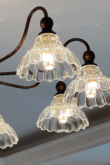 Isolde Vintage Scalloped Glass Chandelier | Looking Up View | Studio perspective view looking up at the illuminated ruffled clear glass shades radiating a bright warm glow | vexa lamps