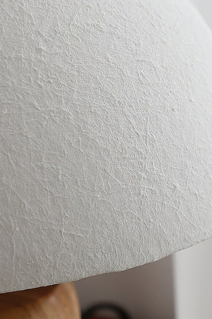 Kira Sculpted Mushroom Table Lamp | Wood, Glass | Macro close-up view highlighting the fine sand-textured stucco finish of the white dome glass lampshade | Detail shot | vexa lamps