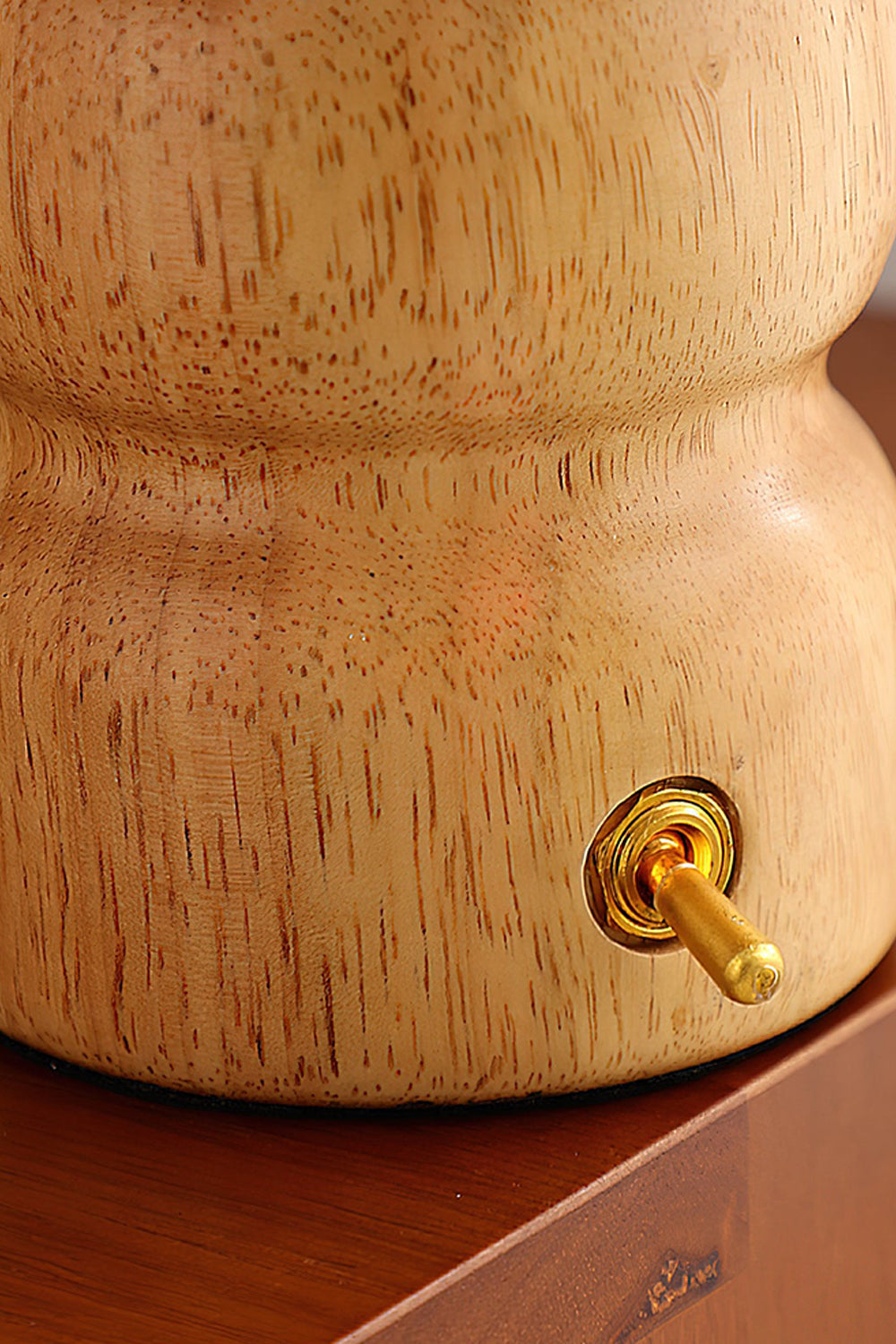 Kira Sculpted Mushroom Table Lamp | Wood, Glass | Close-up focus on the lighter oak wood variant base featuring a polished gold toggle switch | Detail shot | vexa lamps
