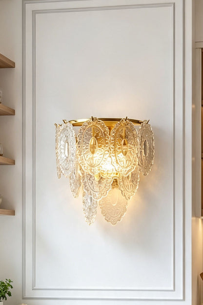 Lavinia Pressed Glass Tier Wall Sconce | Pressed Glass and Brass | Front illuminated view mounted centrally on a white paneled wall | vexa lamps
