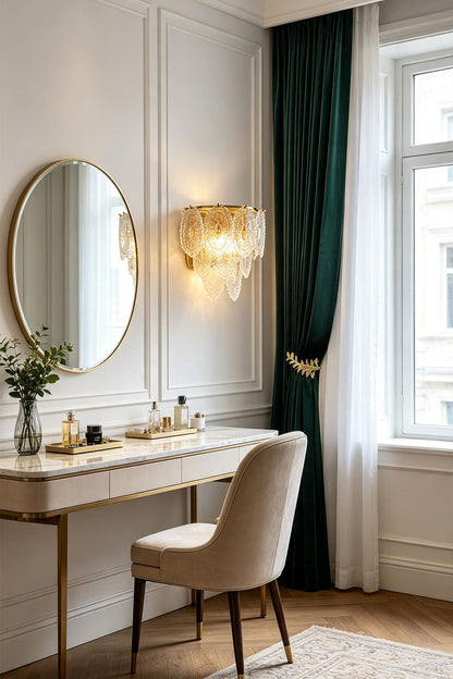 Lavinia Pressed Glass Tier Wall Sconce | Pressed Glass and Brass | Mounted on a wall beside a round mirror over a vanity dressing table | vexa lamps