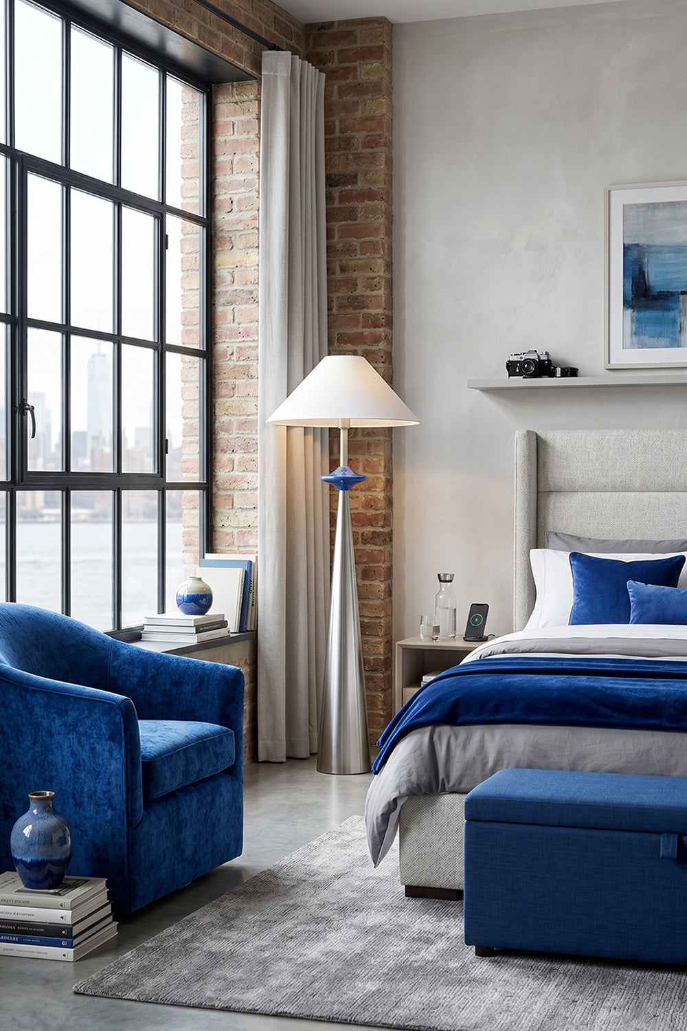 Lazuro Postmodern Cone Floor Light | Metal, Fabric | Standing as an elegant reading lamp in an industrial loft bedroom corner next to a plush blue velvet armchair and a platform bed | vexa lamps