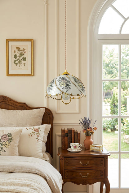 Lillian Retro Floral Pendant Lamp | Glass, Metal | Positioned over a vintage dark wood nightstand next to a classical bed under soft natural light from an arched window | vexa lamps