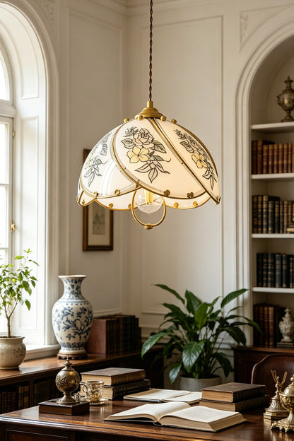 Lillian Retro Floral Pendant Lamp | Glass, Metal | Suspended over a traditional dark wood executive writing desk filled with books and plants in a bright library room | vexa lamps