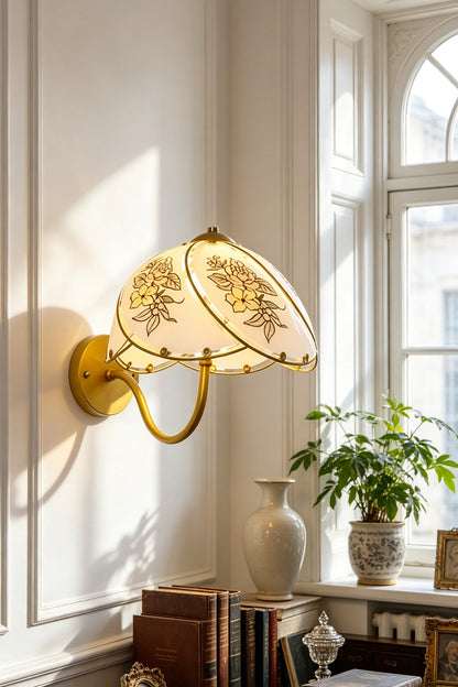 Lillian Retro Floral Wall Lamp | Glass, Metal | Mounted next to a bright window over a wooden writing desk with books in a classic home study | vexa lamps