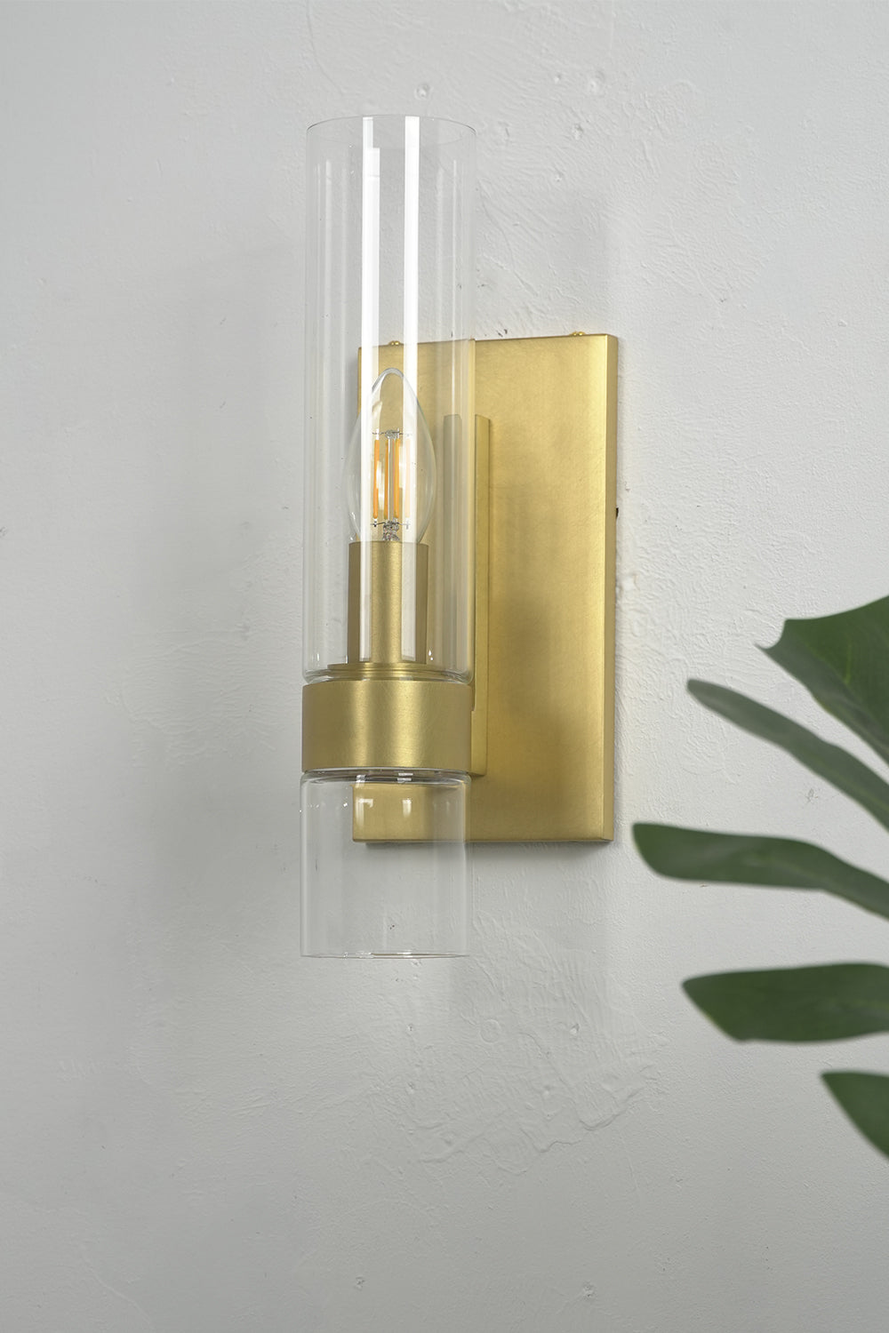 Linear metallic brass glass wall sconce | Brass, Glass | Close-up view on a clean white wall | vexa lamps