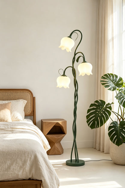 Linnea Tulip Bloom Floor Lamp | Glass and Green Metal | Standing next to a bed and potted plants in a bright bedroom | vexa lamps