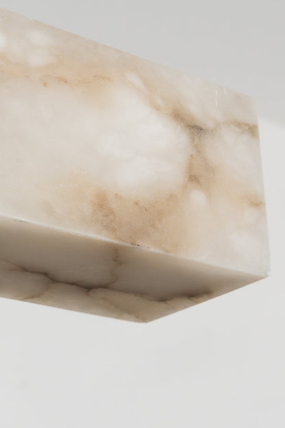 Liora Linear Alabaster Pendant Light | Natural Alabaster and Black Metal | Close-up view of the unlit white stone end profile showcasing its natural organic texture | vexa lamps