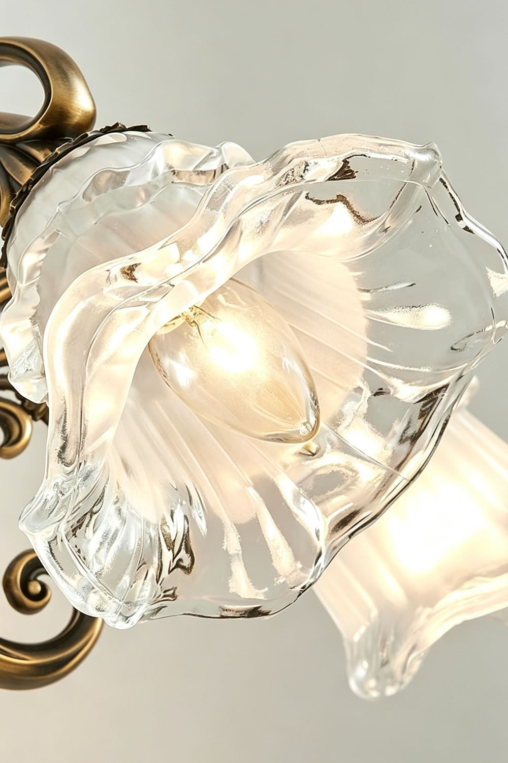 Lisette Blossom Glass Brass Wall Lamp | Glass and Brass | Close-up view highlighting the flower blossom glass shade with ruffled edges | vexa lamps