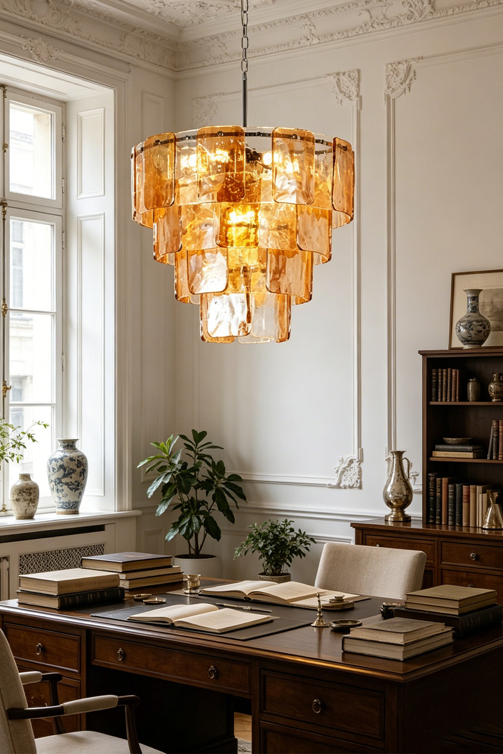 Lucia Tiered Amber Glass Chandelier | Glass, Metal | Illuminating a traditional study room or dining space, casting a rich golden glow over a dark wood table with ornate wall decor | vexa lamps