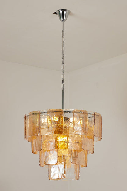 Lucia Tiered Amber Glass Chandelier | Glass, Metal | Studio variant view of a narrower tiered version of the amber glass chandelier illuminated against a plain background | vexa lamps