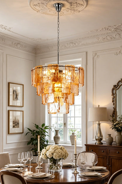 Lucia Tiered Amber Glass Chandelier | Glass, Metal | Closer staged room view of the grand amber glass chandelier illuminating a classical dining table setup with candles and flowers | vexa lamps