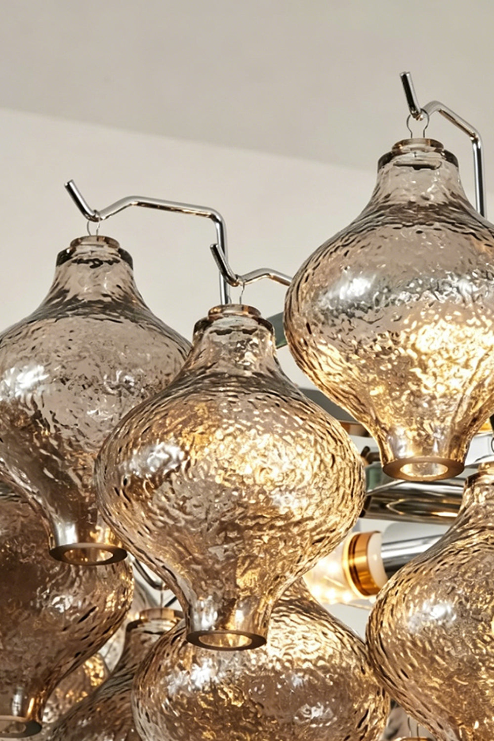 Close-up of the Lucina Tiered Smoked Glass Chandelier showcasing its hand-blown smoky amber glass components.