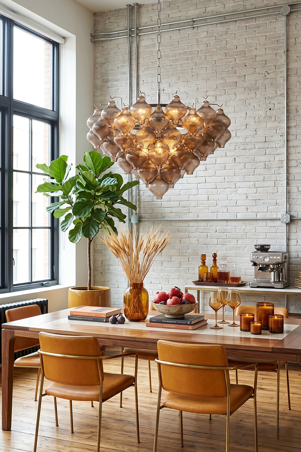 Lucina Tiered Smoked Glass Chandelier illuminating a modern dining space with a warm ambiance.
