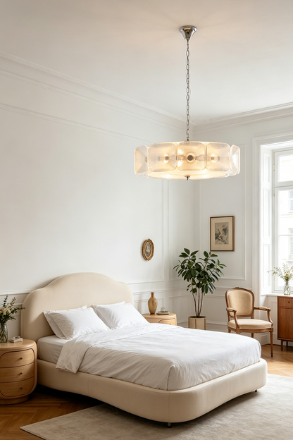 Lyra Geometric Glass Chandelier | Glass, Metal | Positioned as a calming bedroom light fixture casting a warm glow over a minimalist cream bed and neutral decor | vexa lamps