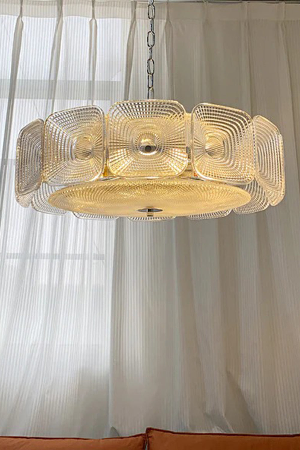 Lyra Geometric Glass Chandelier | Glass, Metal | Hanging elegantly in front of a tall window with translucent white linen curtains, radiating a cozy amber light | vexa lamps