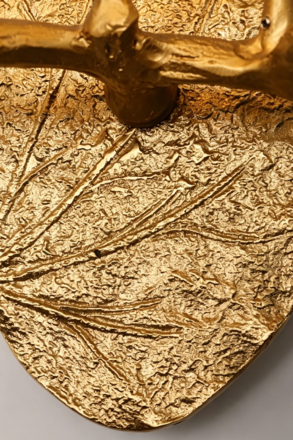 Magnolia Arbor Brass Wall Lamp | Brass, Glass | Macro shot showcasing the heavy botanical leaf veins and bark texture of the gold oval backplate | Detail shot | vexa lamps