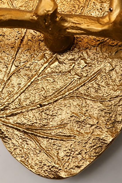 Magnolia Arbor Brass Wall Lamp | Brass, Glass | Macro shot showcasing the heavy botanical leaf veins and bark texture of the gold oval backplate | Detail shot | vexa lamps