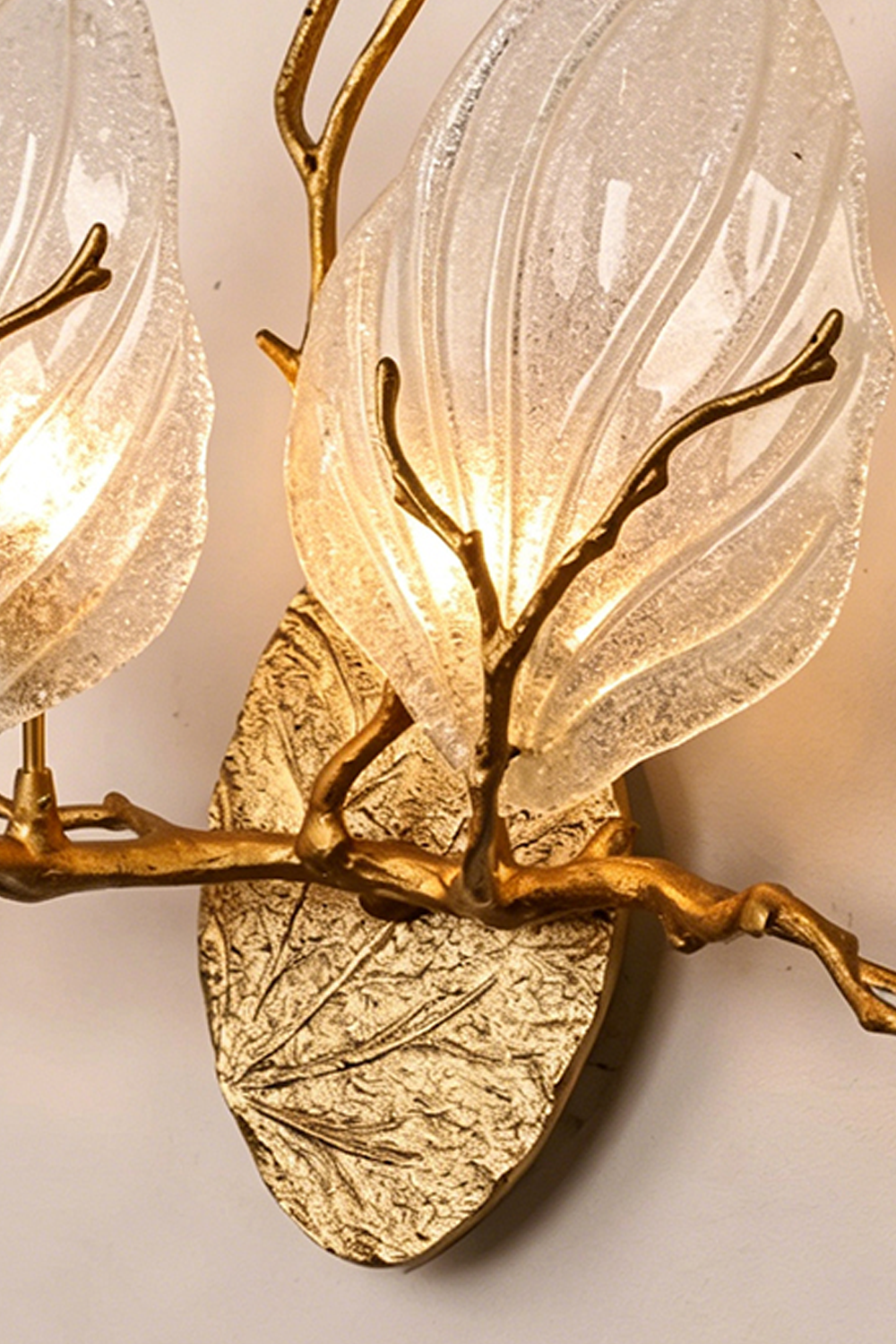 Magnolia Arbor Brass Wall Lamp | Brass, Glass | Close-up showing both glowing glass shades and the intersection of the organic brass branches on the base | Detail shot | vexa lamps