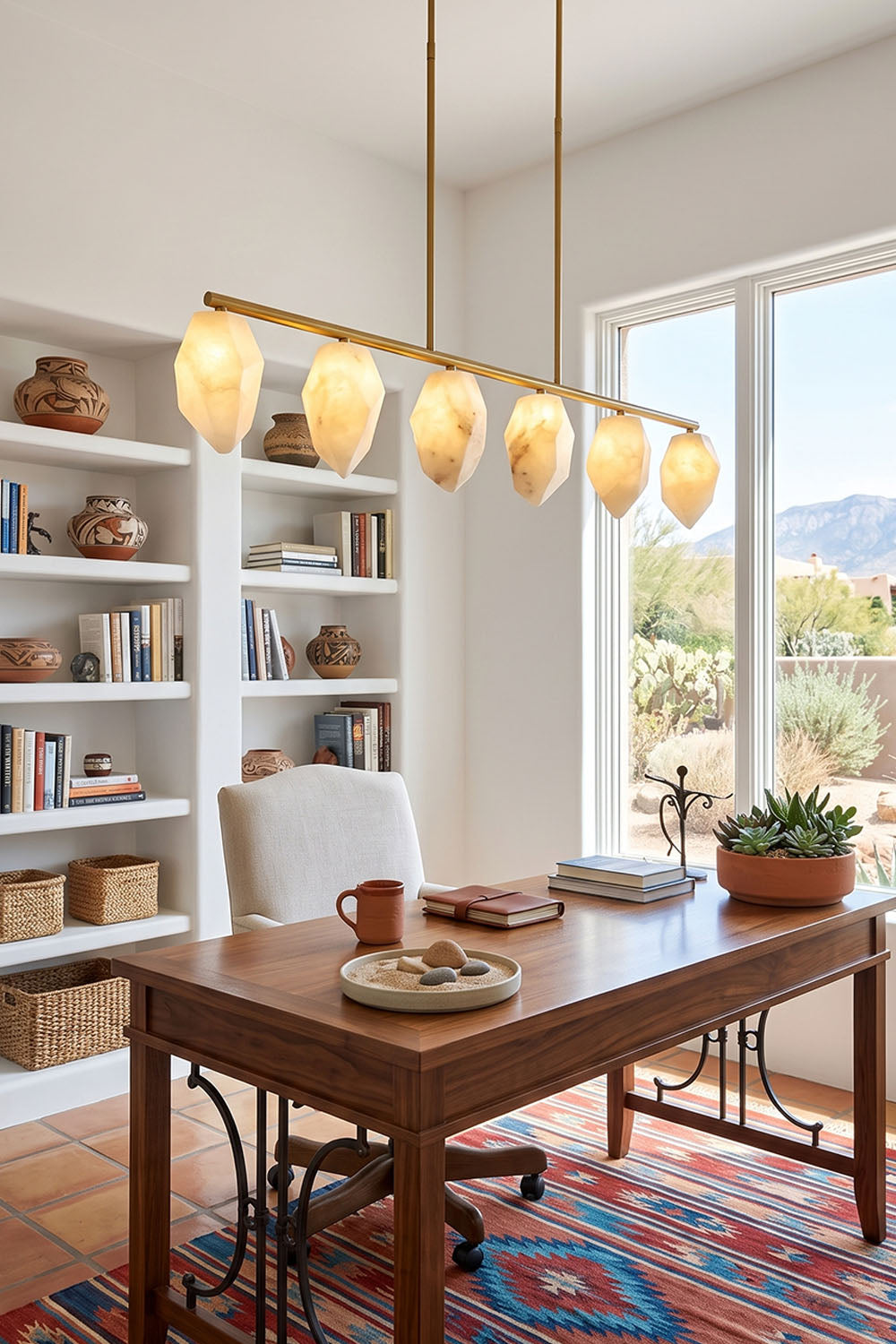 Manon Alabaster Drop Linear Chandelier | Natural Alabaster and Brass | Displayed in a home office over a wooden desk with a large bookshelf | vexa lamps