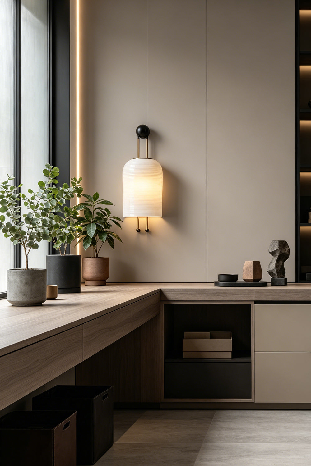 Marlow Linear Ribbed Glass Wall Lamp | Glass, Metal | Installed as a sleek wall sconce above a long minimalist wooden counter in a modern kitchen area | vexa lamps