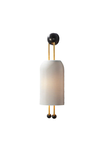 Marlow Linear Ribbed Glass Wall Lamp | Glass, Metal | Modern pill-shaped white horizontally ribbed glass wall sconce with gold brass vertical rods and black sphere accents | Isolated lit product shot on white background | vexa lamps