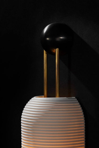 Marlow Linear Ribbed Glass Wall Lamp | Glass, Metal | Macro close-up under dark studio lighting highlighting the top black mounting base and fine horizontal glass ribs | Detail shot | vexa lamps