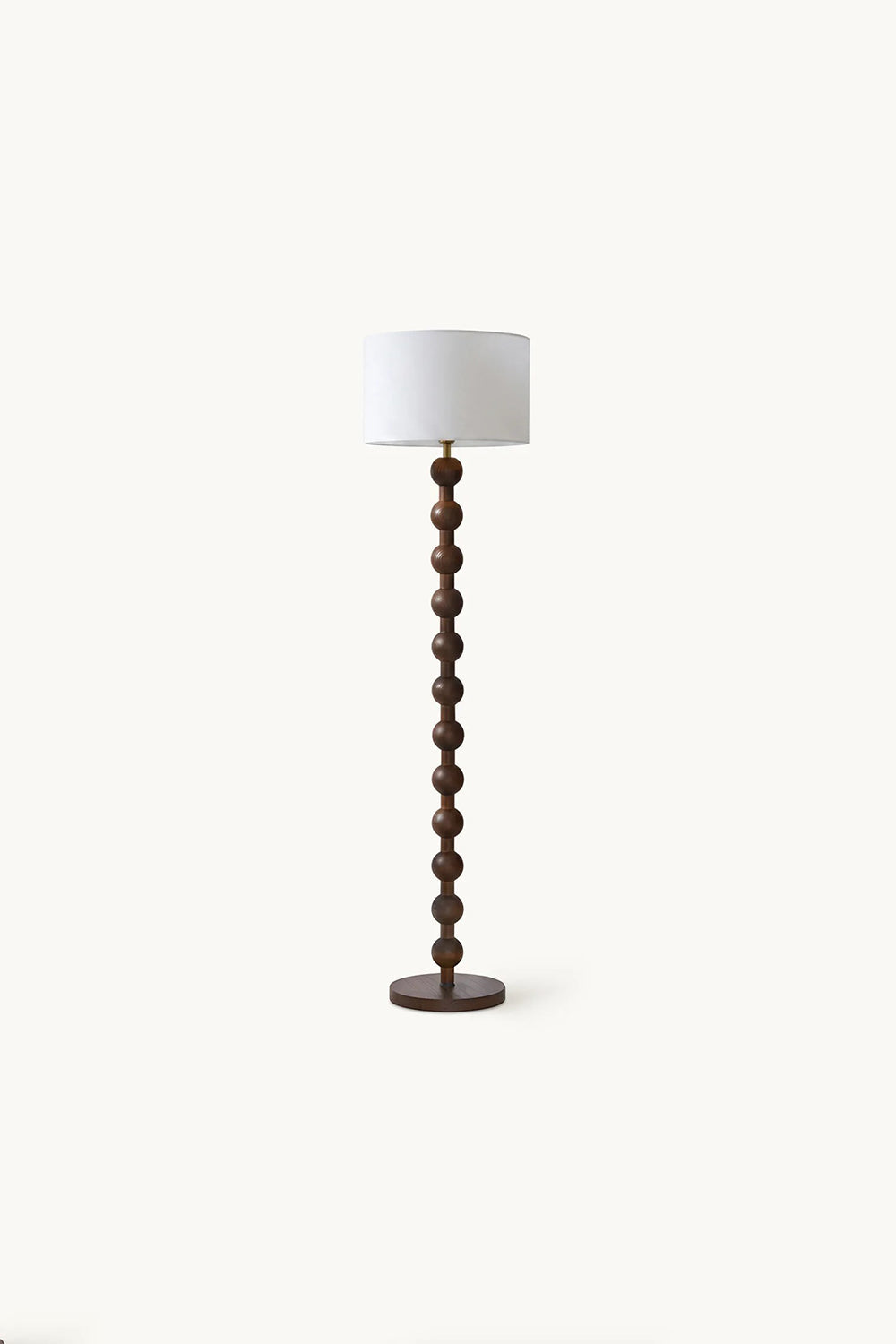 Marlow Stacked Wood Floor Lamp | Wood, Fabric | Studio full-length shot of the unlit dark wood bobbin floor lamp against a plain light beige background | vexa lamps