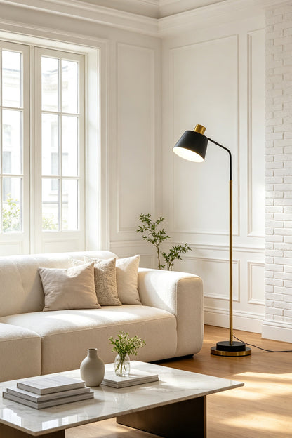 Marlowe Gooseneck Reading Floor Lamp | Matte Black and Brass | Casting a warm reading light beside a cozy white sofa in a contemporary living room | vexa lamps