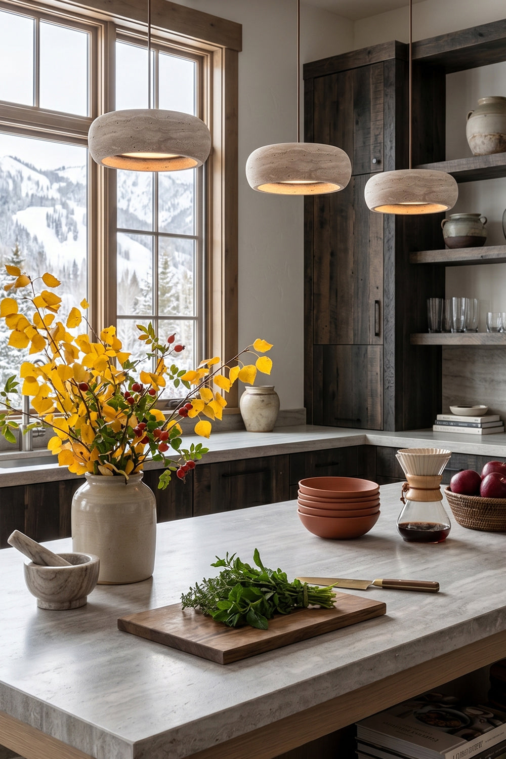 Maro Travertine Donut Pendant Light | Travertine, Metal | A trio of three linear travertine donut pendants illuminating a white marble kitchen island counter in a bright rustic kitchen | vexa lamps