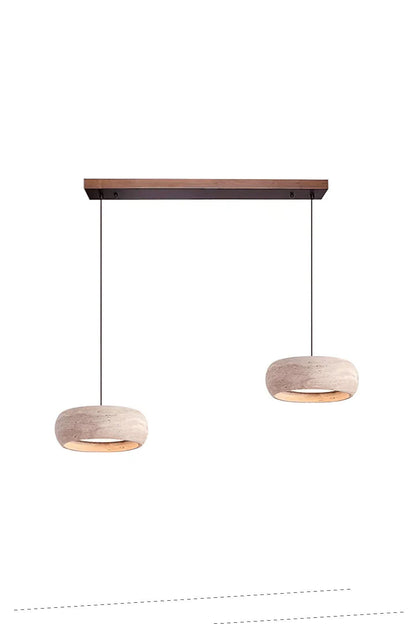 Maro Travertine Donut Pendant Light | Travertine, Metal, Wood | Studio view of the two-light variant featuring a pair of travertine donut lamps hanging from a short wooden linear ceiling canopy | vexa lamps