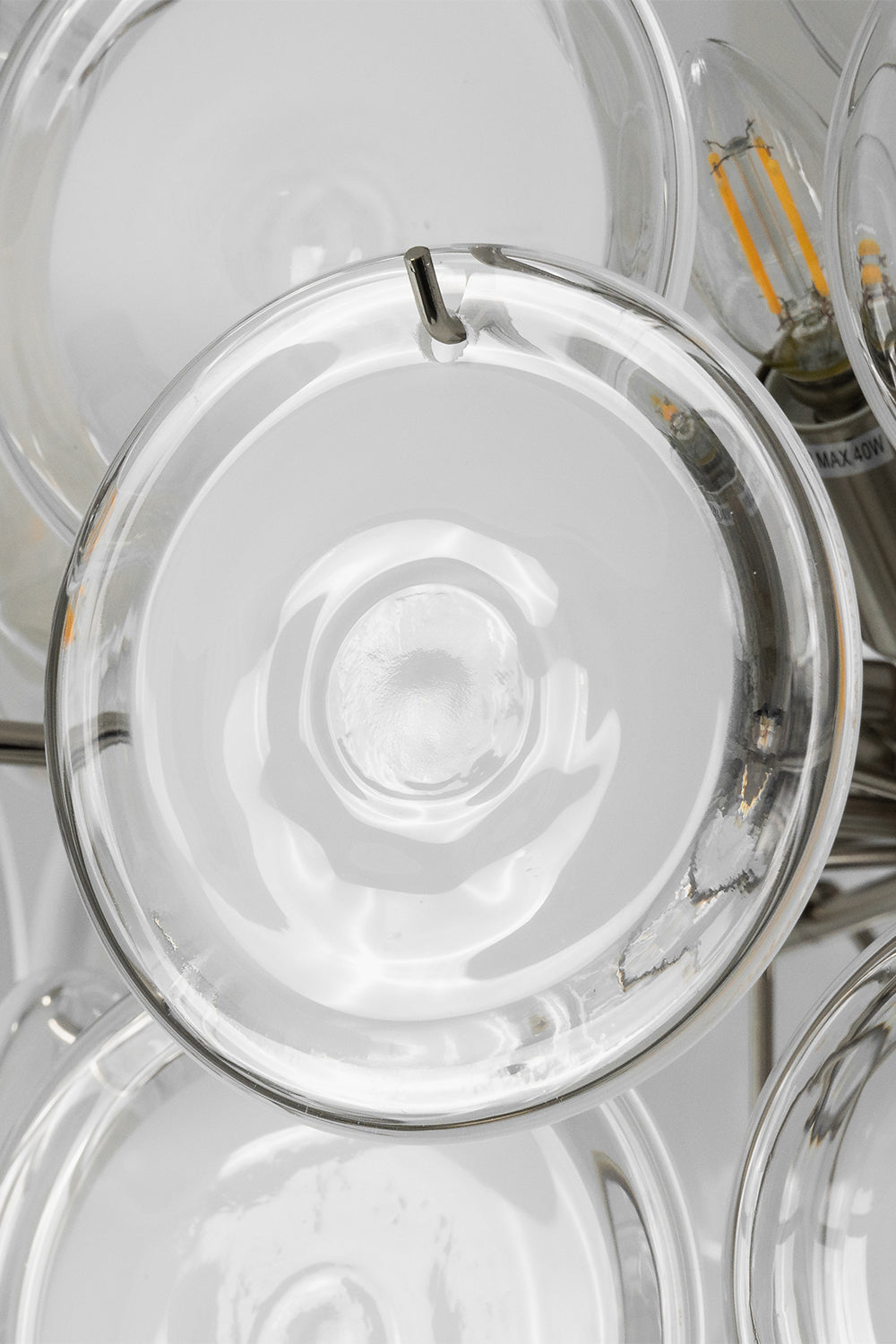 Mirella Circular Glass Pane Ceiling Light | Discs Texture Detail | Macro shot focusing on the layers of circular translucent glass panes secured onto the metallic structural framework | Detail shot | vexa lamps