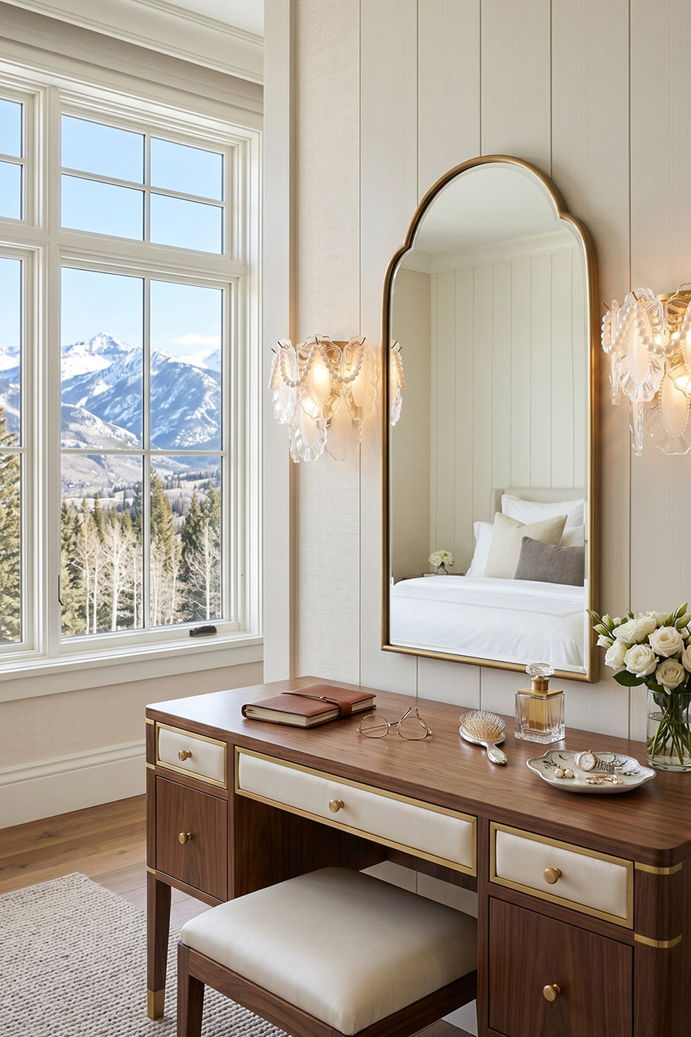 Elegant Mirella Pearl and Glass Wall Lamp illuminating a stylish vanity in a scenic mountain view setting.