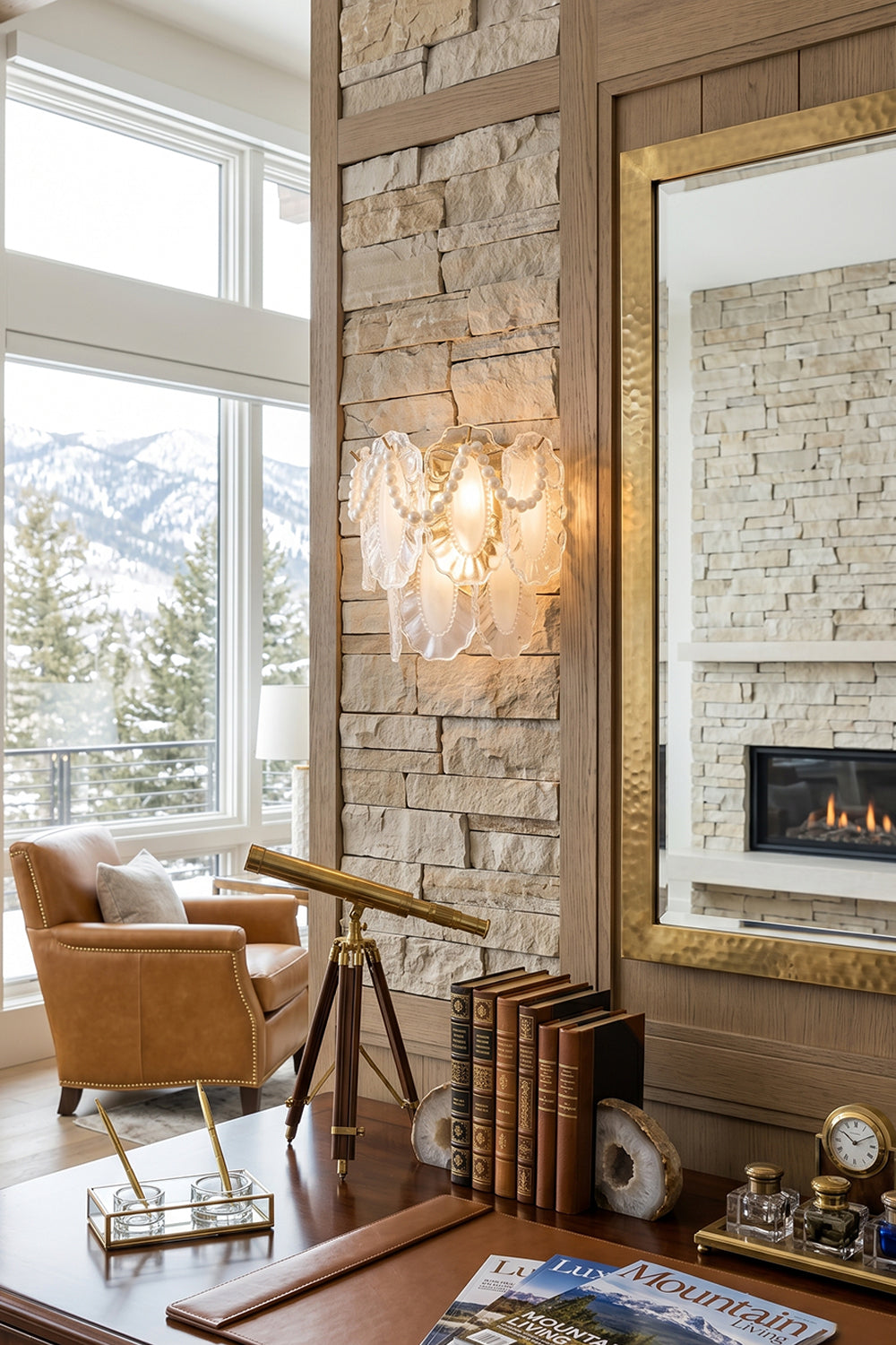 Mirella Pearl and Glass Wall Lamp illuminating a modern living space with stone walls and scenic mountain views.