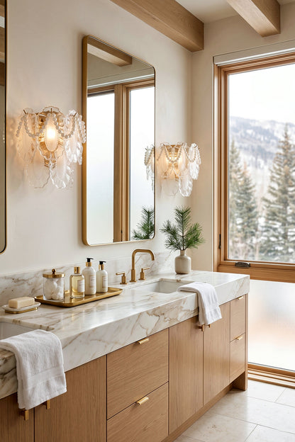Mirella Pearl and Glass Wall Lamp illuminating a stylish bathroom with marble countertop and gold accents.