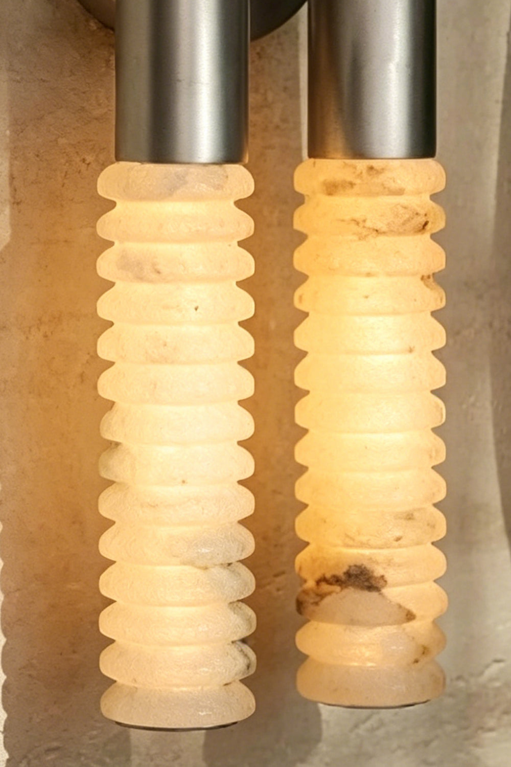 Monolith Arc Alabaster Wall Lamp | Alabaster, Metal | Macro view of the lit ribbed alabaster surface showing natural stone variations | Detail shot | vexa lamps
