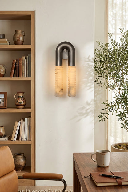 Monolith Arc Alabaster Wall Lamp | Alabaster, Metal | Wall-mounted in a modern home office next to a wooden bookshelf and desk | vexa lamps