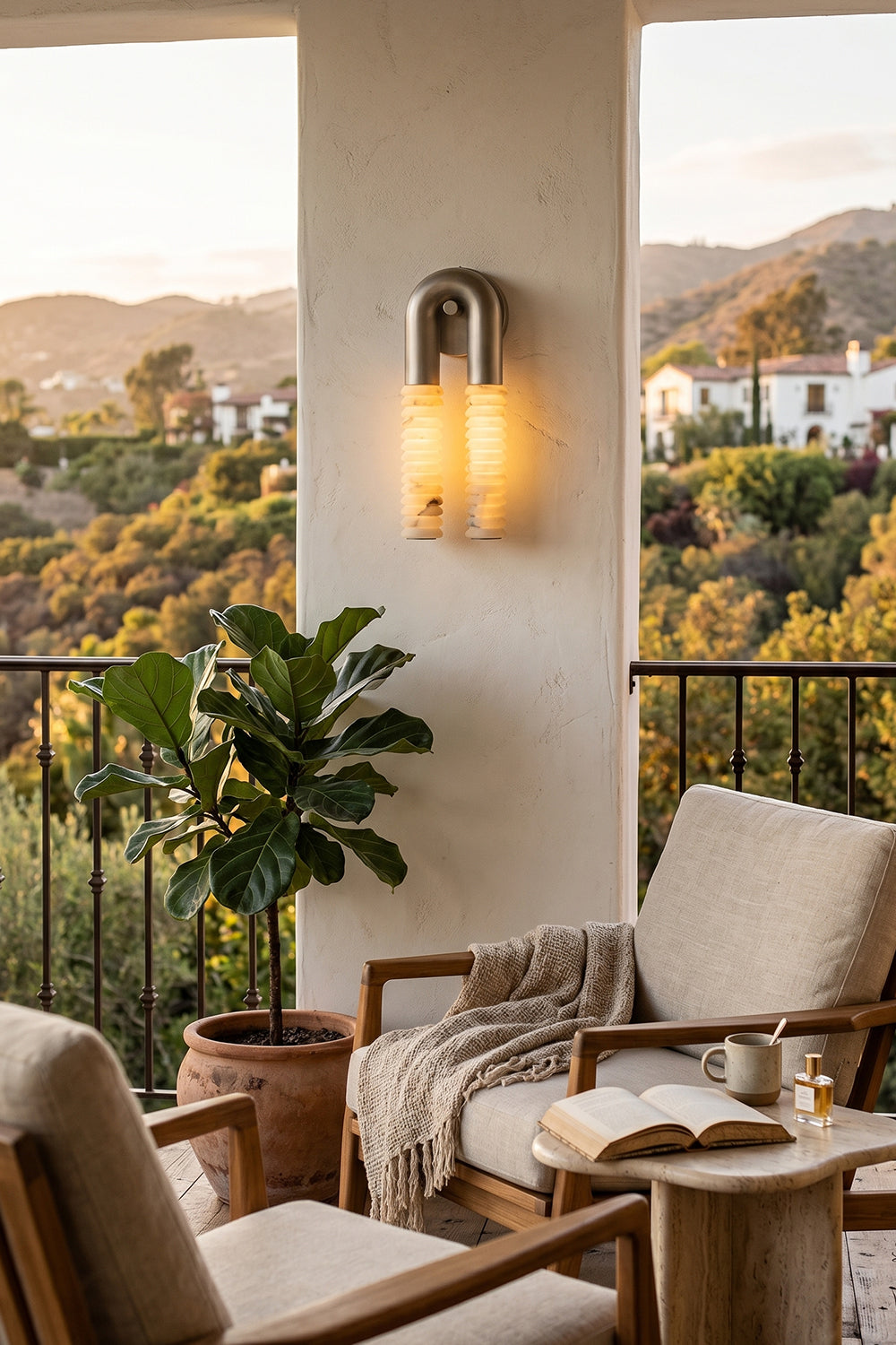 Monolith Arc Alabaster Wall Lamp | Alabaster, Metal | Outdoor terrace lighting at sunset with a comfortable lounge chair and scenic views | vexa lamps