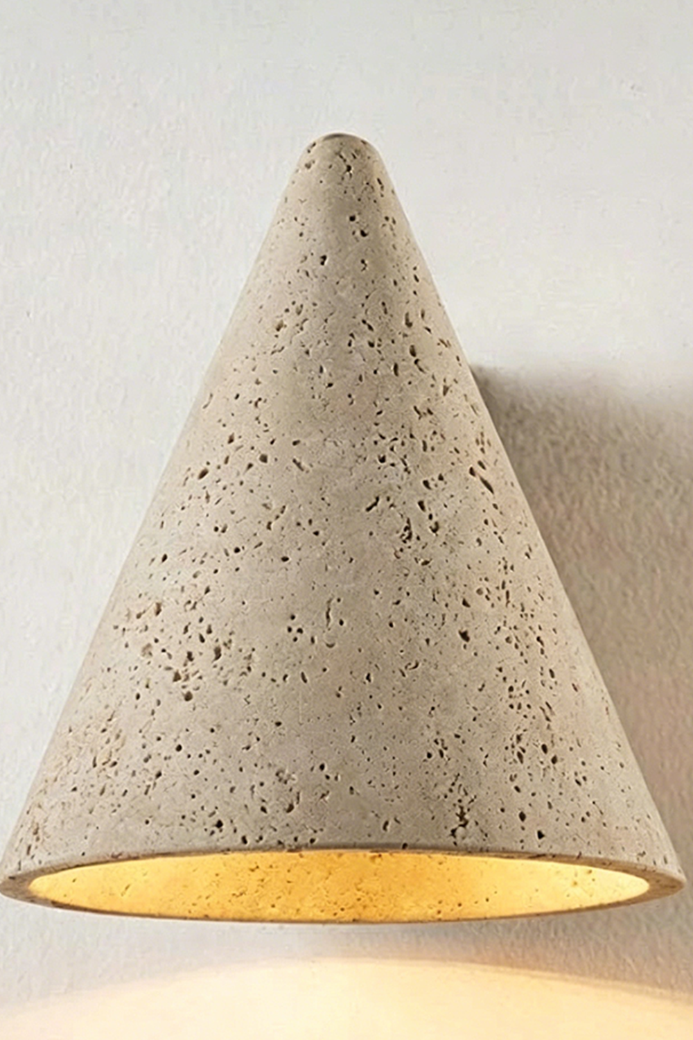 Monolith Cone Travertine Wall Sconce showcasing the unique texture and design of natural yellow travertine.