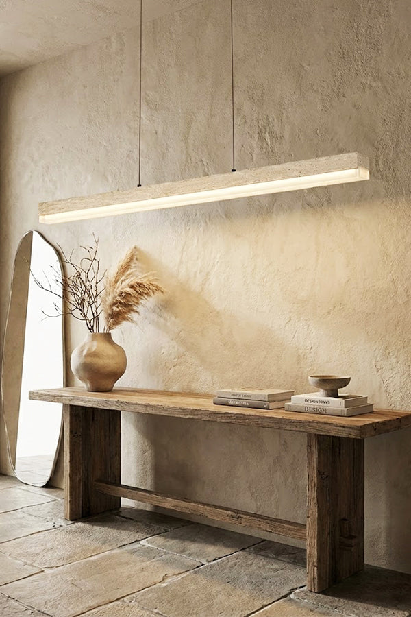 Natural travertine linear lamp against a stone wall | Travertine, Wood, Acrylic | Over a rustic wooden console table | vexa lamps