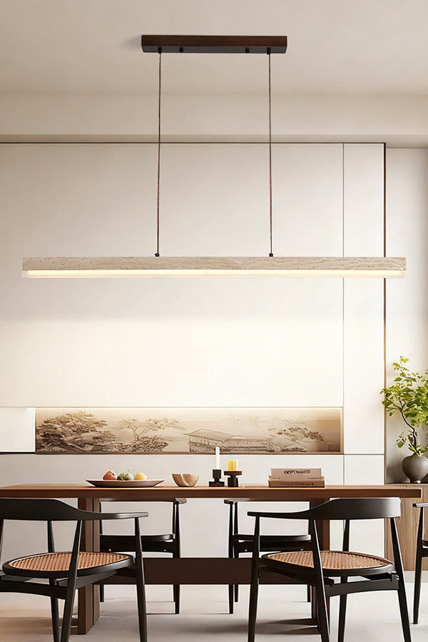 Lit linear travertine pendant over a set dining table | Travertine, Wood, Acrylic | Contemporary room with abstract wall art | vexa lamps