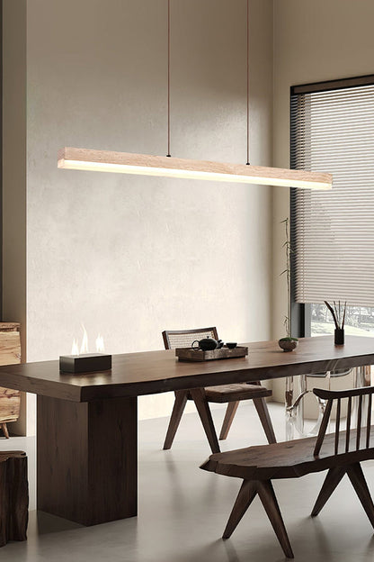 Minimalist travertine linear light fixture | Travertine, Wood, Acrylic | Over a dark wood dining table and bench | vexa lamps